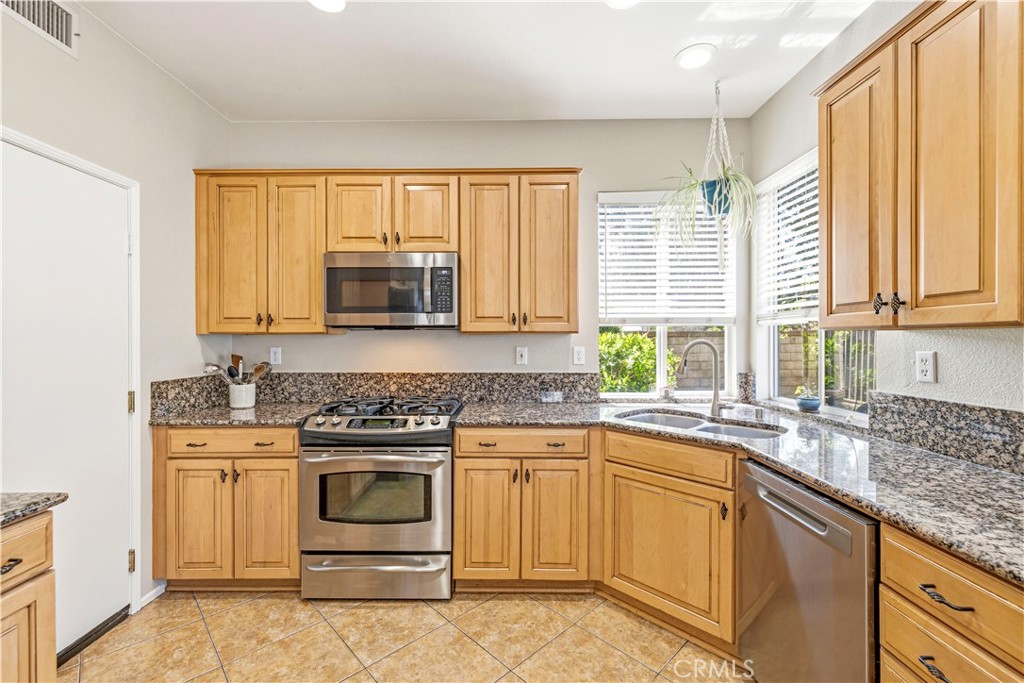 28033 Memory Lane Valencia, CA 91354 - Photo 11 of 40 a kitchen with a stove a sink and a window