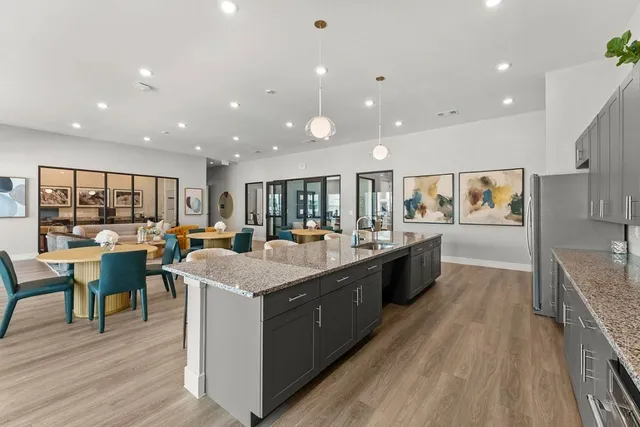 a large kitchen with stainless steel appliances lots of counter top space