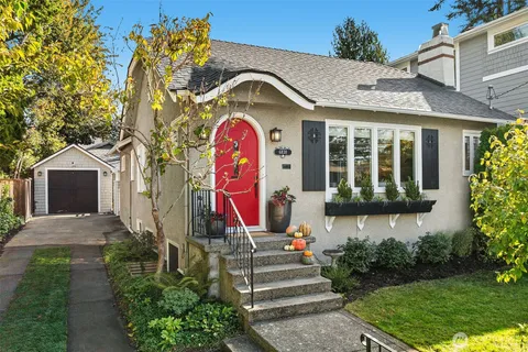 a front view of a house with a yard and fountain in middle