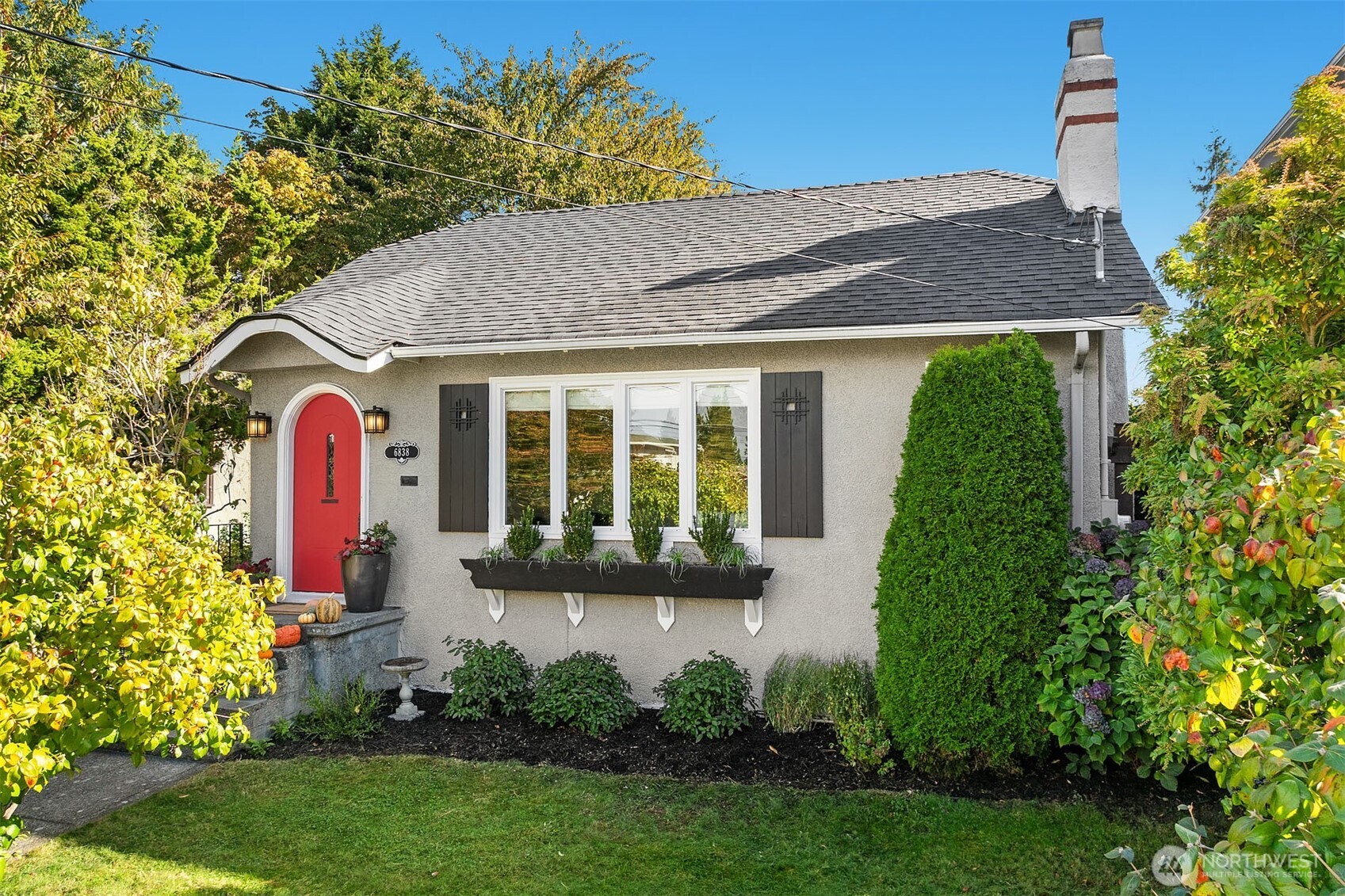 6838 30th Avenue Northeast Seattle, WA 98115 - Photo 32 of 34 a front view of a house with a yard