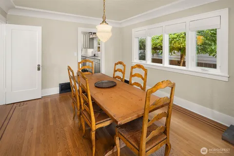 a view of a dining room with furniture and wooden floor