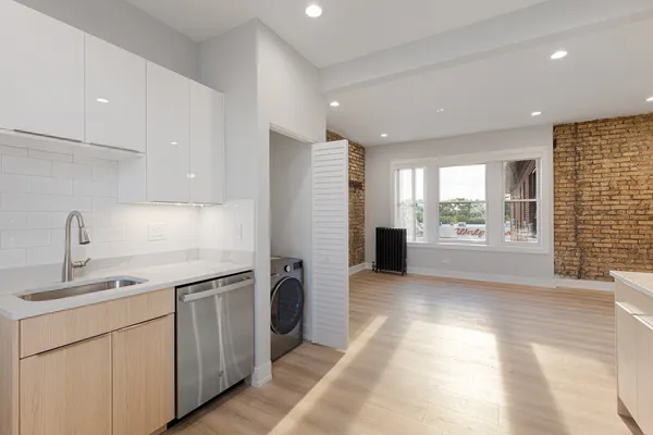 a kitchen with a sink stainless steel appliances and cabinets