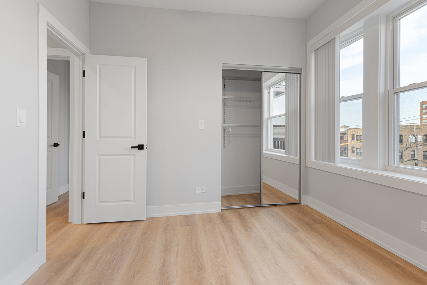 7423 North Clark Street, Unit 2 Chicago, IL 60626 - Photo 9 of 13 a view of an empty room with wooden floor and a window