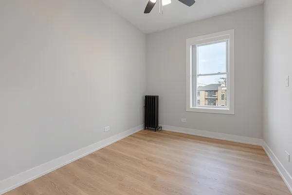 an empty room with windows and closet