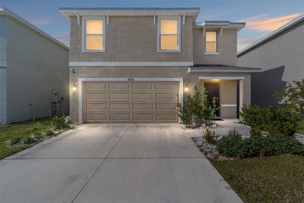 a view of a brick house with potted plants