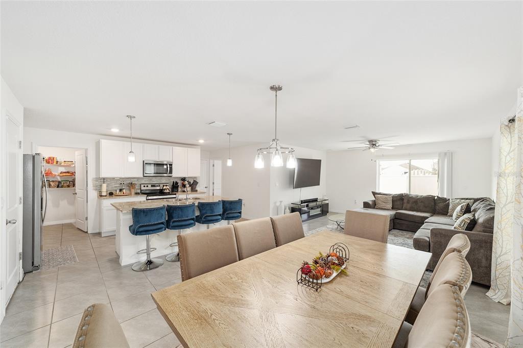 8696 Southwest 46th Avenue Ocala, FL 34476 - Photo 14 of 51 a living room with furniture kitchen view and a chandelier