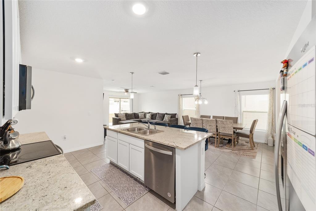 8696 Southwest 46th Avenue Ocala, FL 34476 - Photo 19 of 51 a kitchen with a stove a sink and a refrigerator