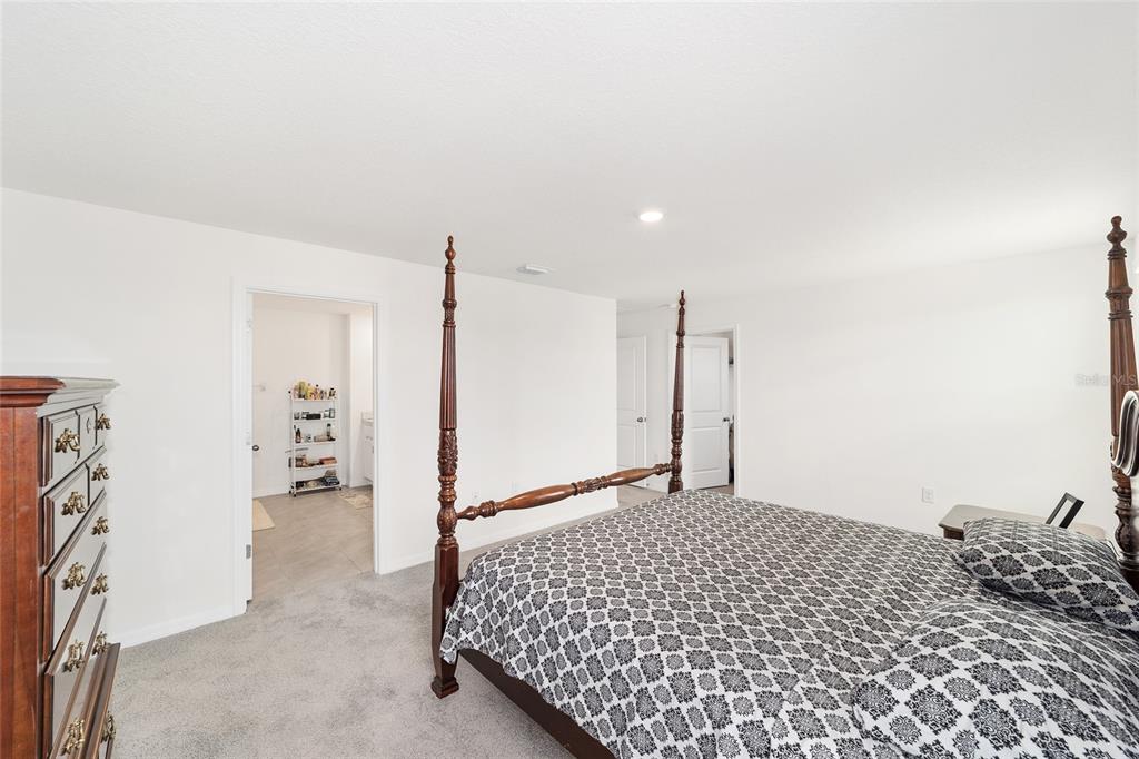 8696 Southwest 46th Avenue Ocala, FL 34476 - Photo 28 of 51 a bedroom with a bed and a walk in closet