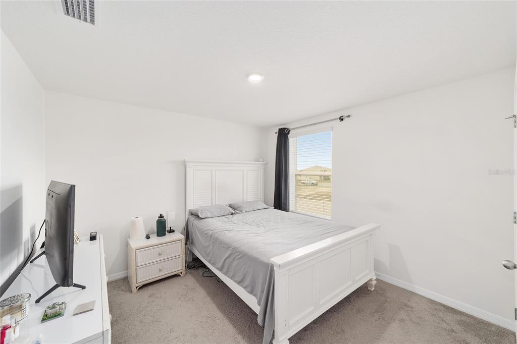 8696 Southwest 46th Avenue Ocala, FL 34476 - Photo 31 of 51 a bedroom with a bed and a flat screen tv