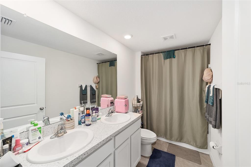 8696 Southwest 46th Avenue Ocala, FL 34476 - Photo 33 of 51 a bathroom with a sink vanity mirror and toilet