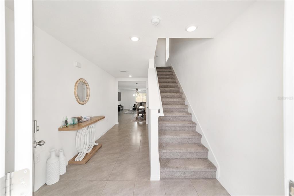 8696 Southwest 46th Avenue Ocala, FL 34476 - Photo 6 of 51 a hallway with a white walls and cabinets