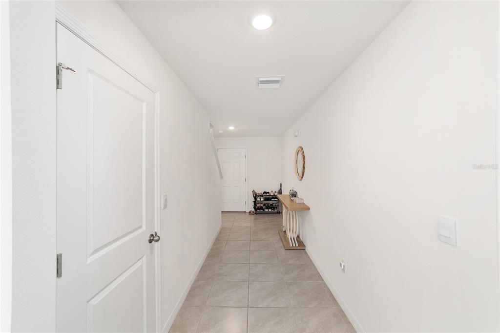 8696 Southwest 46th Avenue Ocala, FL 34476 - Photo 7 of 51 a view of a hallway with closet and a couch