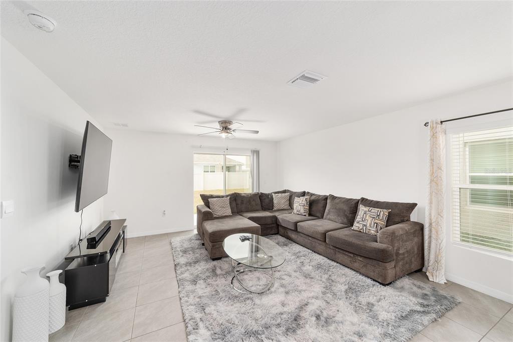 8696 Southwest 46th Avenue Ocala, FL 34476 - Photo 10 of 51 a living room with furniture and a flat screen tv