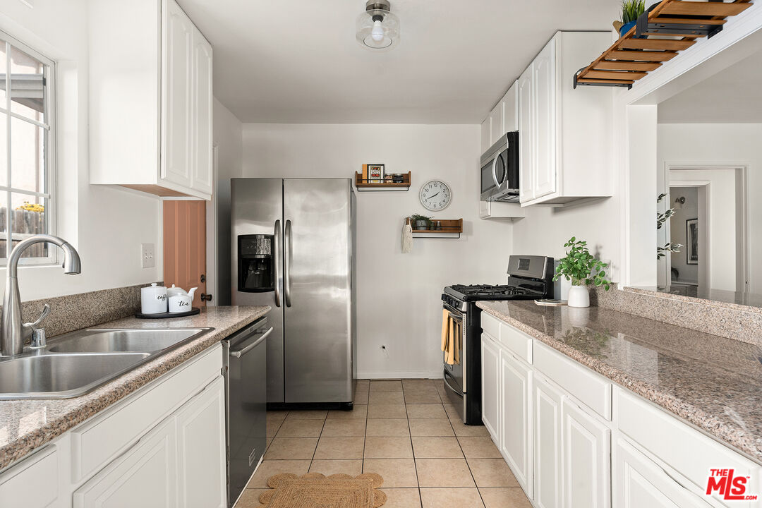 4014 Baywood Street Los Angeles, CA 90039 - Photo 7 of 25 a kitchen with stainless steel appliances granite countertop a sink stove and refrigerator