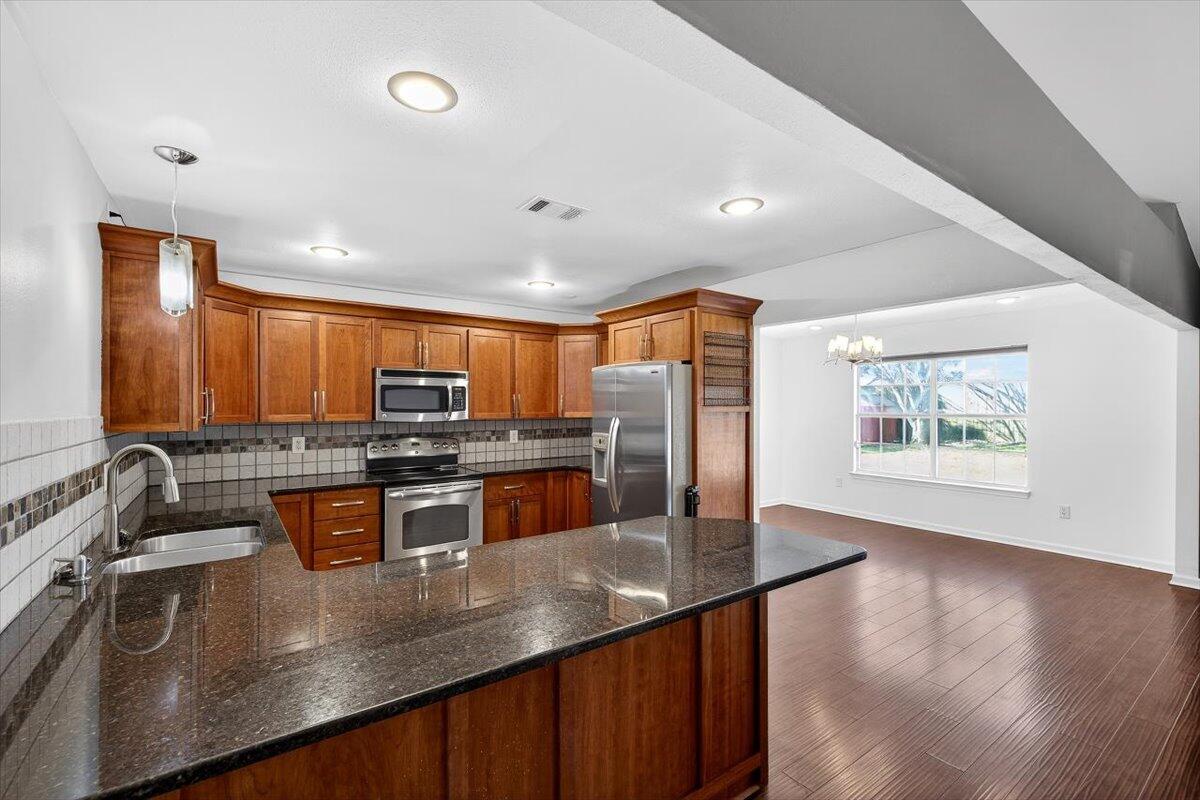 608 Northview Drive Crestview, FL 32536 - Photo 13 of 39 a kitchen with stainless steel appliances granite countertop a sink a stove and a refrigerator