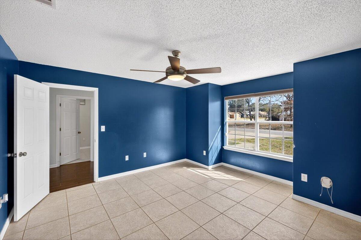 608 Northview Drive Crestview, FL 32536 - Photo 18 of 39 a bedroom with a large bed and a chandelier