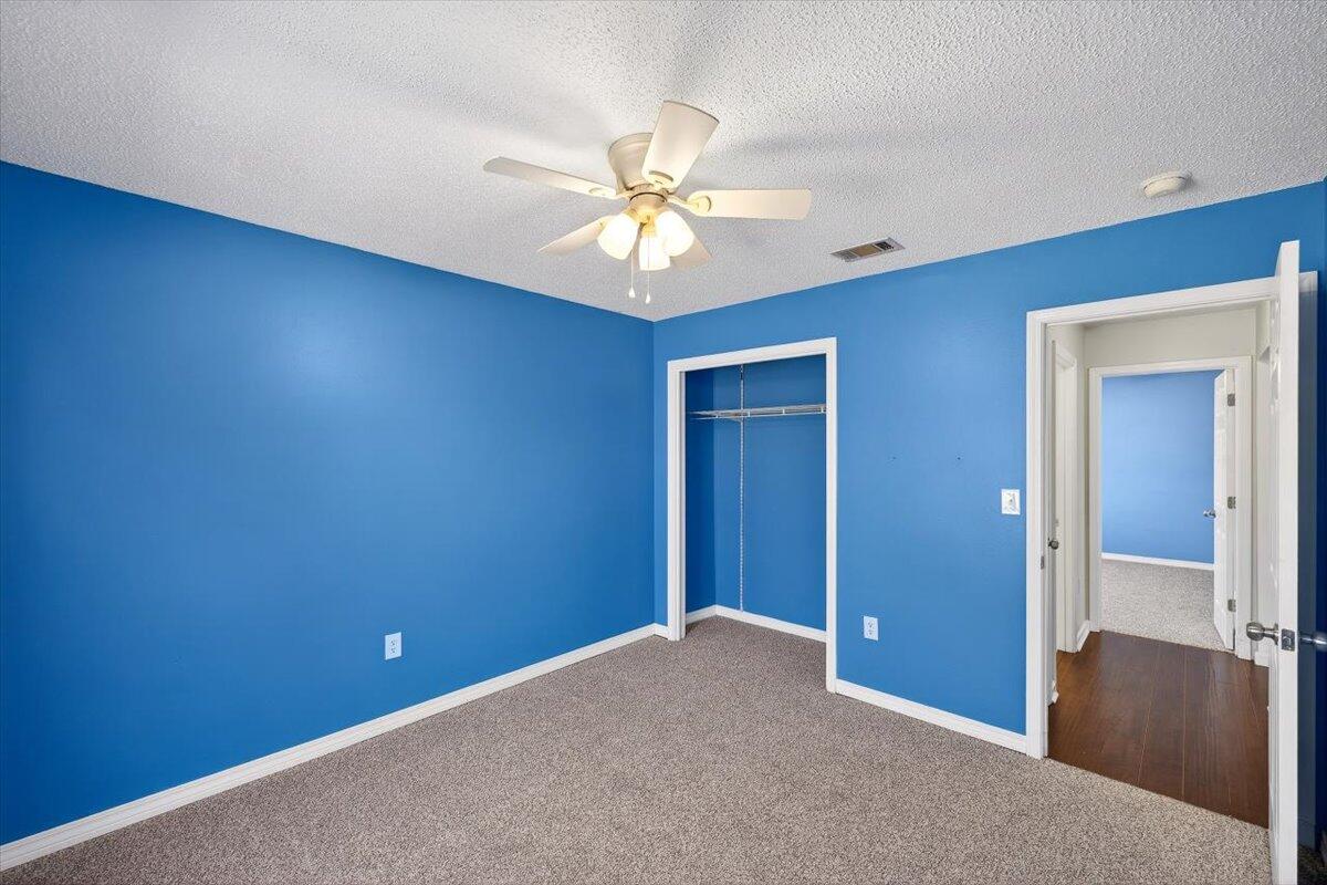 608 Northview Drive Crestview, FL 32536 - Photo 32 of 39 an empty room with closet and a chandelier fan