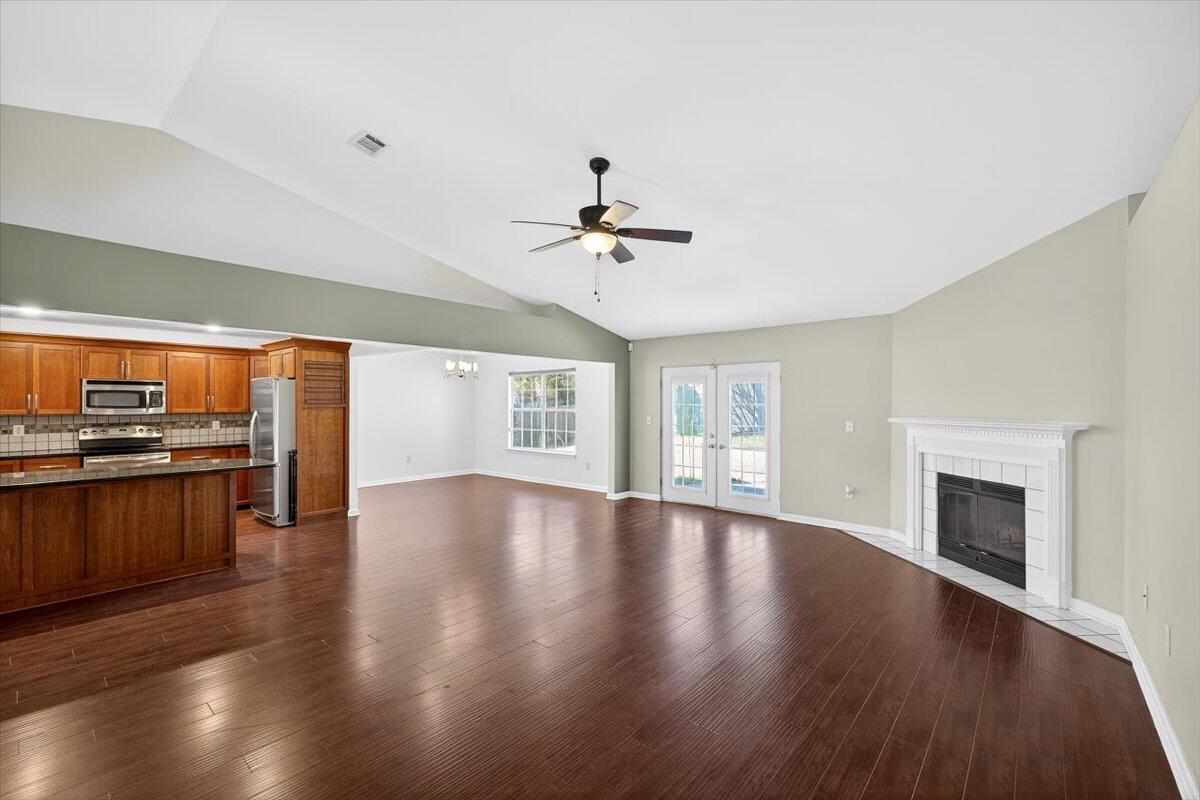 608 Northview Drive Crestview, FL 32536 - Photo 7 of 39 wooden floor in an empty room with a kitchen