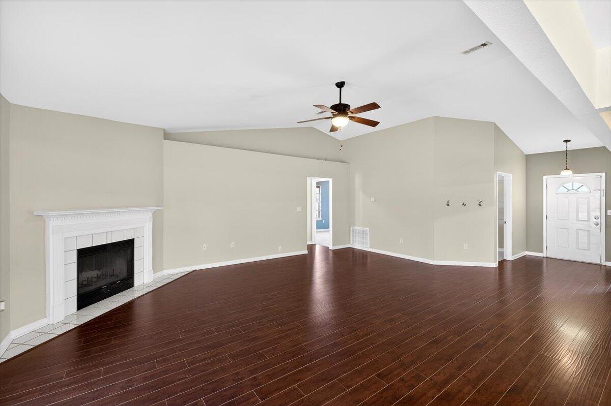 608 Northview Drive Crestview, FL 32536 - Photo 9 of 39 a view of an empty room with wooden floor and a fireplace