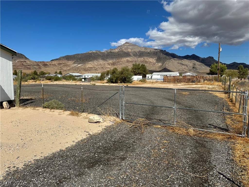 3270 West Simkins Road Pahrump, NV 89060 - Photo 6 of 36 Dramatic mountain vistas frame this gated, gravel-surfaced property ready for your vision.