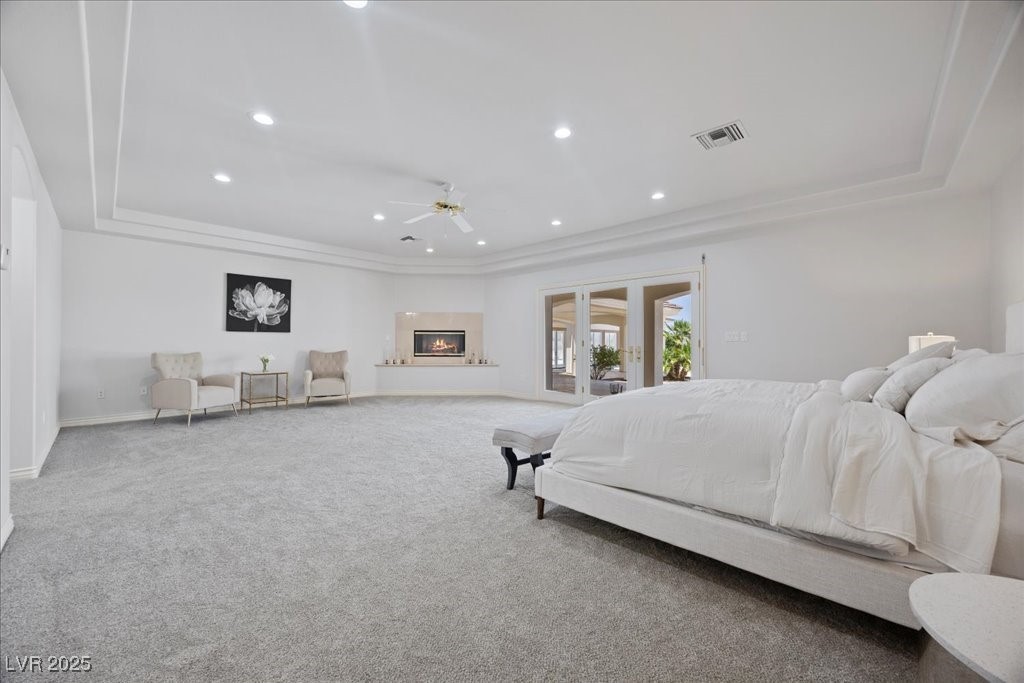 640 Quail Covey Road Henderson, NV 89002 - Photo 13 of 75 Bedroom with carpet floors, access to outside, a raised ceiling, and recessed lighting and Fireplace