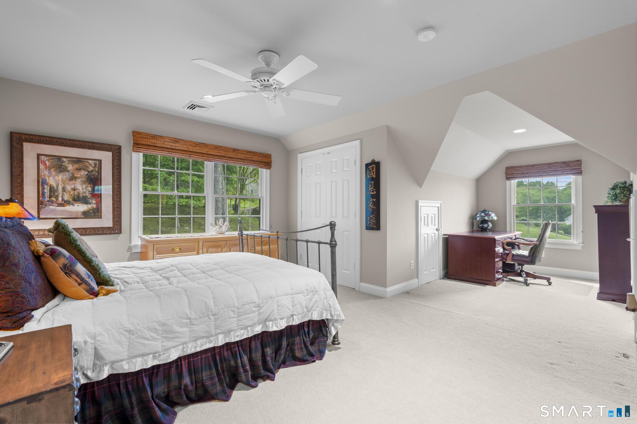 12 Logans Way Danbury, CT 06811 - Photo 25 of 40 a spacious bedroom with a bed a chandelier and a large window