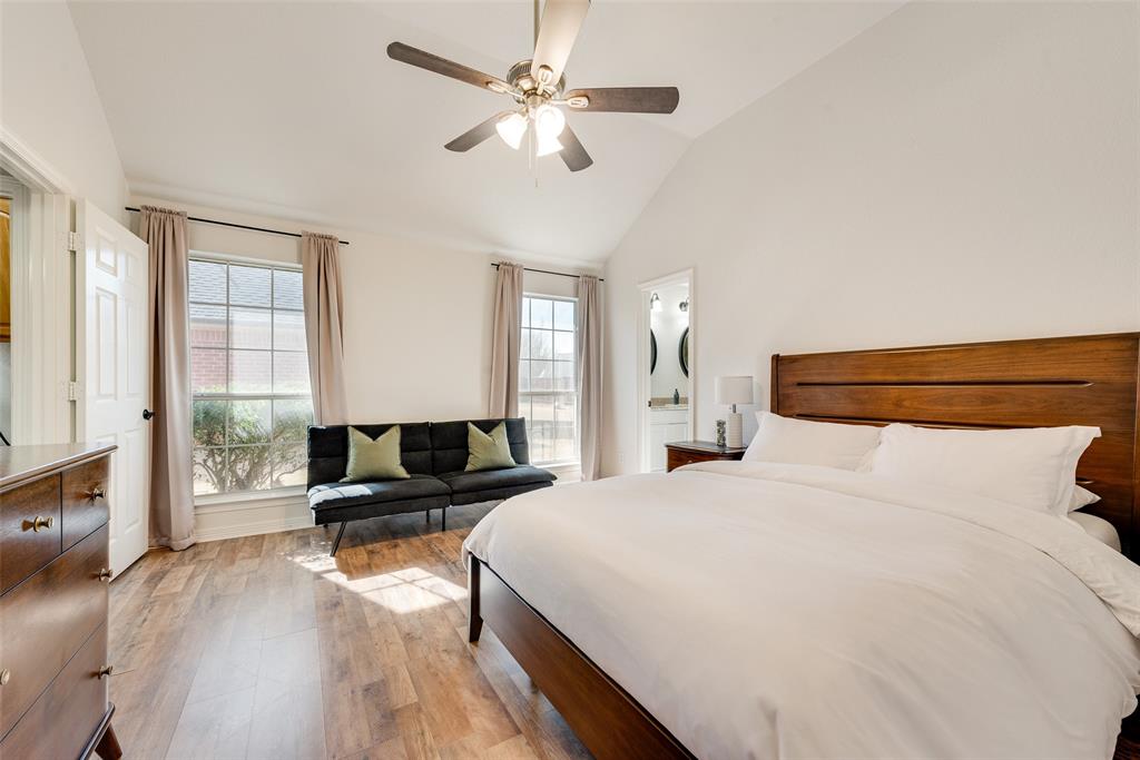 106 Villanova Circle Forney, TX 75126 - Photo 15 of 26 a bedroom with a large bed and a large window
