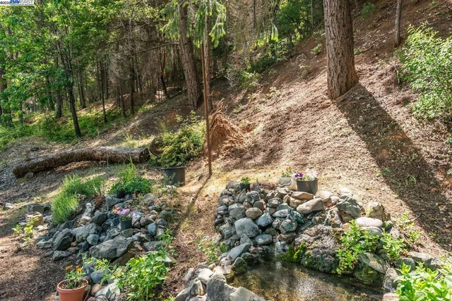 a view of a house with backyard stove and sitting area