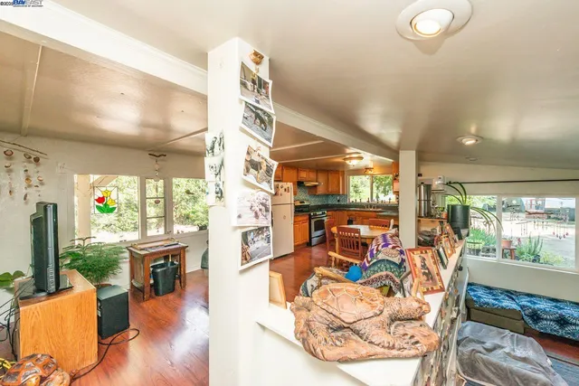 a living room with furniture a fireplace and large windows