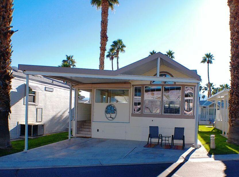 84136 Ave 44, Unit 408 Indio, CA 92203 - Photo 2 of 44 a front view of a house with garden