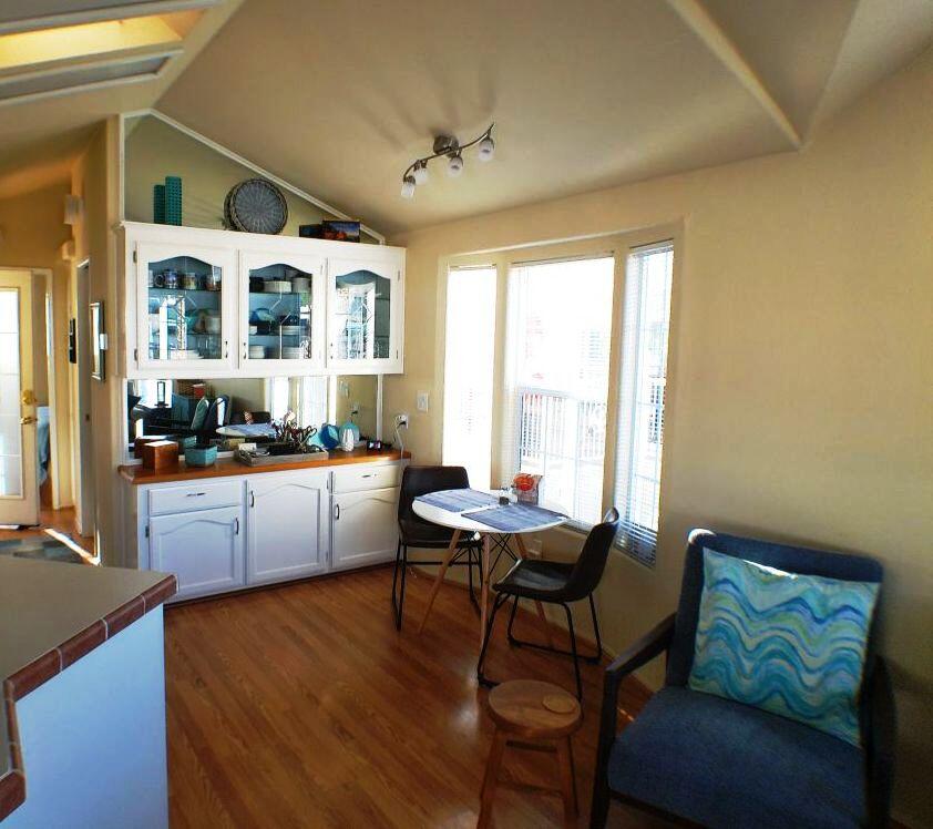 84136 Ave 44, Unit 408 Indio, CA 92203 - Photo 24 of 44 a kitchen with stainless steel appliances kitchen island granite countertop a table and chairs in it