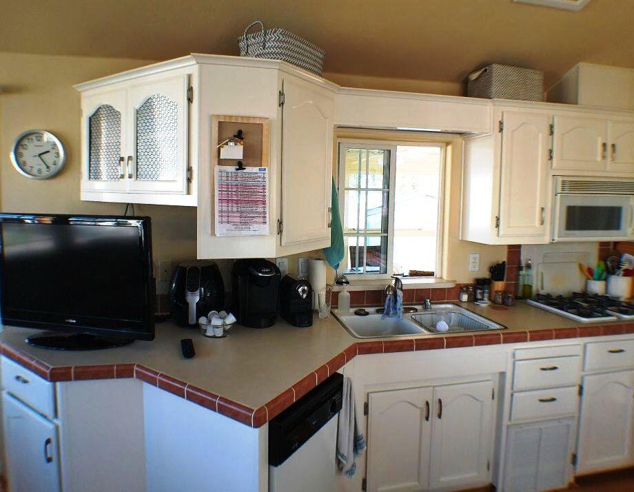 84136 Ave 44, Unit 408 Indio, CA 92203 - Photo 31 of 44 a kitchen with stainless steel appliances a sink a stove and a microwave