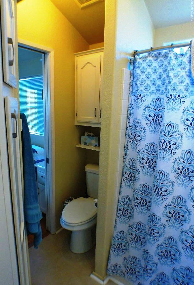 84136 Ave 44, Unit 408 Indio, CA 92203 - Photo 34 of 44 a bathroom with a toilet and a shower