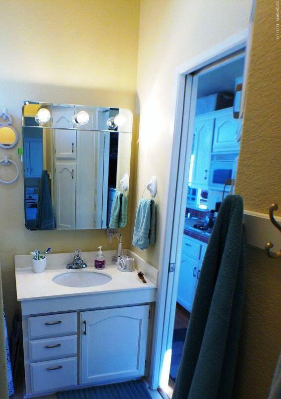 84136 Ave 44, Unit 408 Indio, CA 92203 - Photo 36 of 44 a bathroom with a sink and a mirror