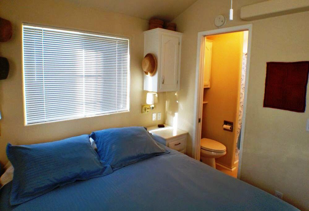 84136 Ave 44, Unit 408 Indio, CA 92203 - Photo 39 of 44 a bedroom with a bed and wooden floor