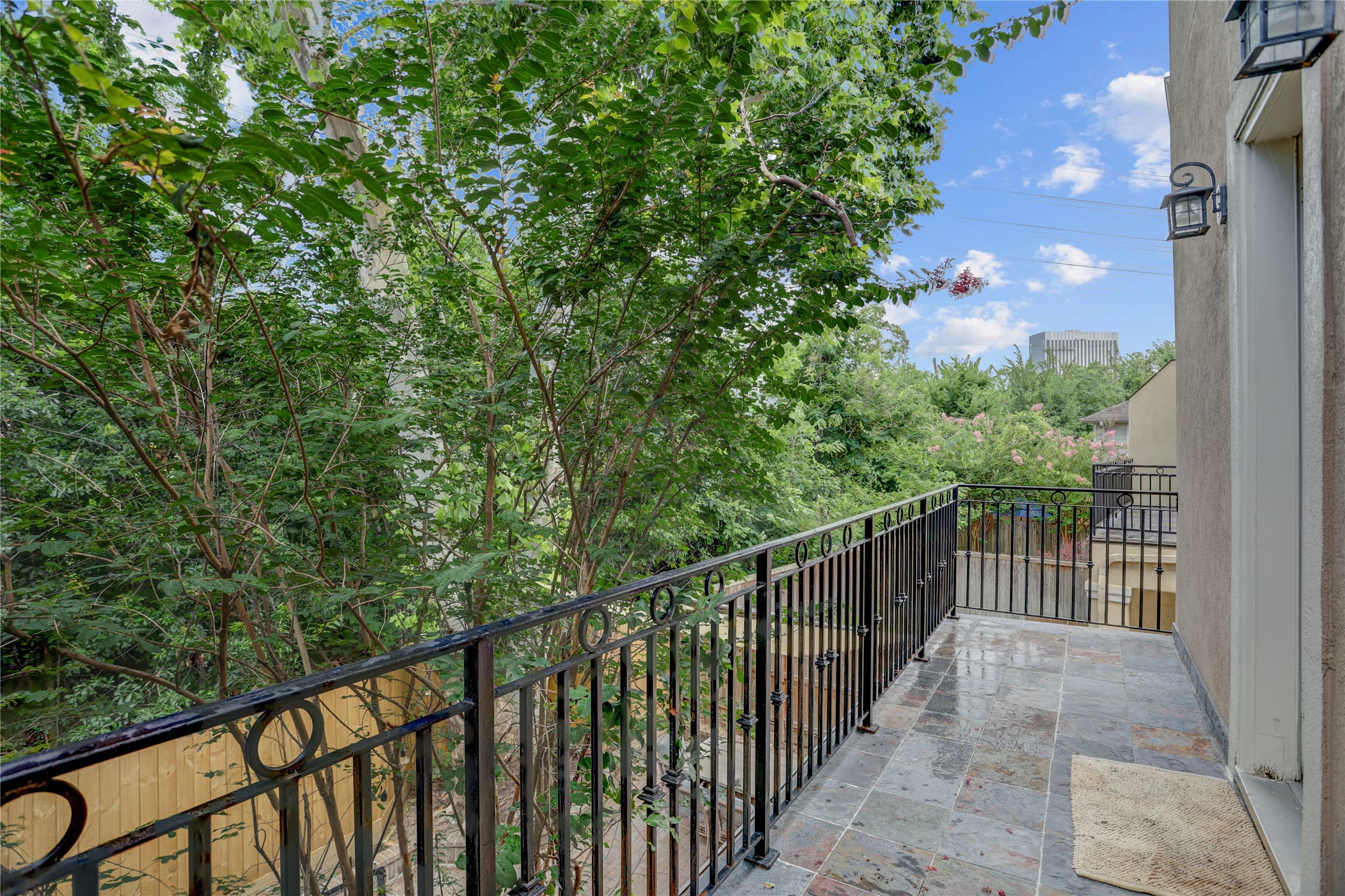 4262 Childress Street, Unit B Houston, TX 77005 - Photo 13 of 22 a balcony with trees in front of it