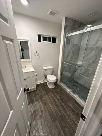 a bathroom with a toilet a sink and shower