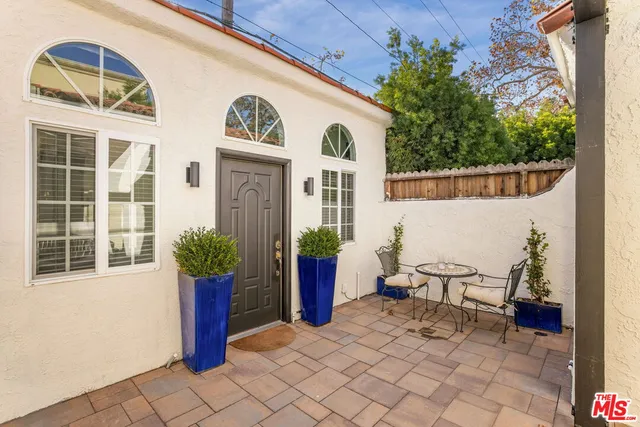 a view of a chairs and table in backyard of the house
