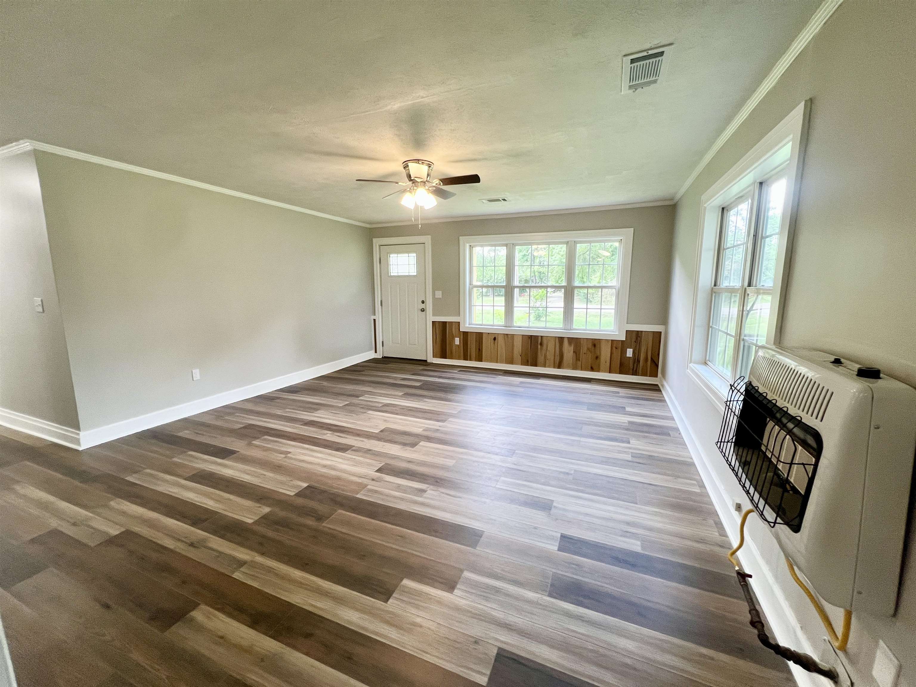 250 Ranch Street Savannah, TN 38372 - Photo 13 of 29 a view of a livingroom with wooden floor and a ceiling fan
