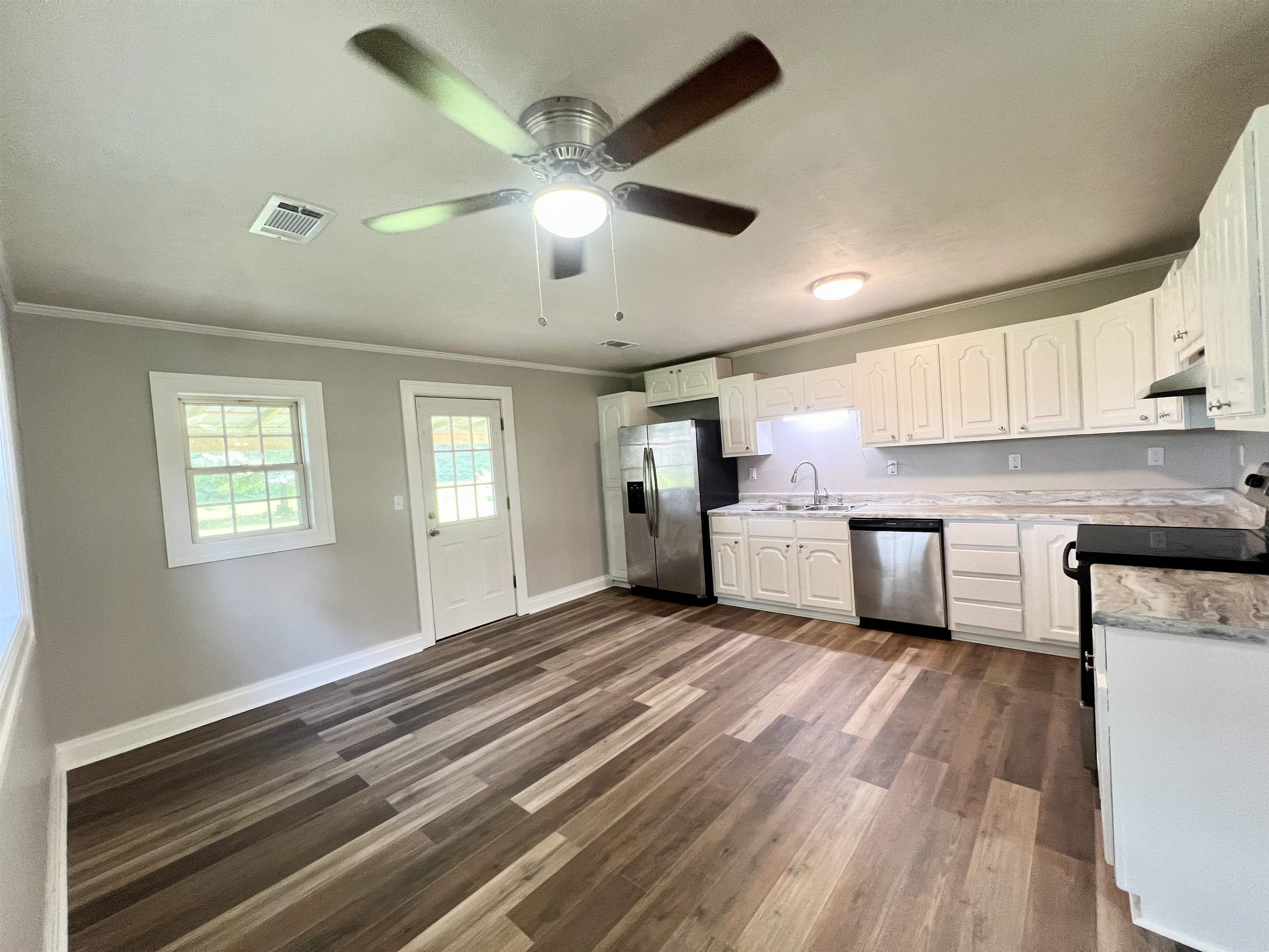 250 Ranch Street Savannah, TN 38372 - Photo 14 of 29 a open kitchen with kitchen island a stove cabinets and wooden floor