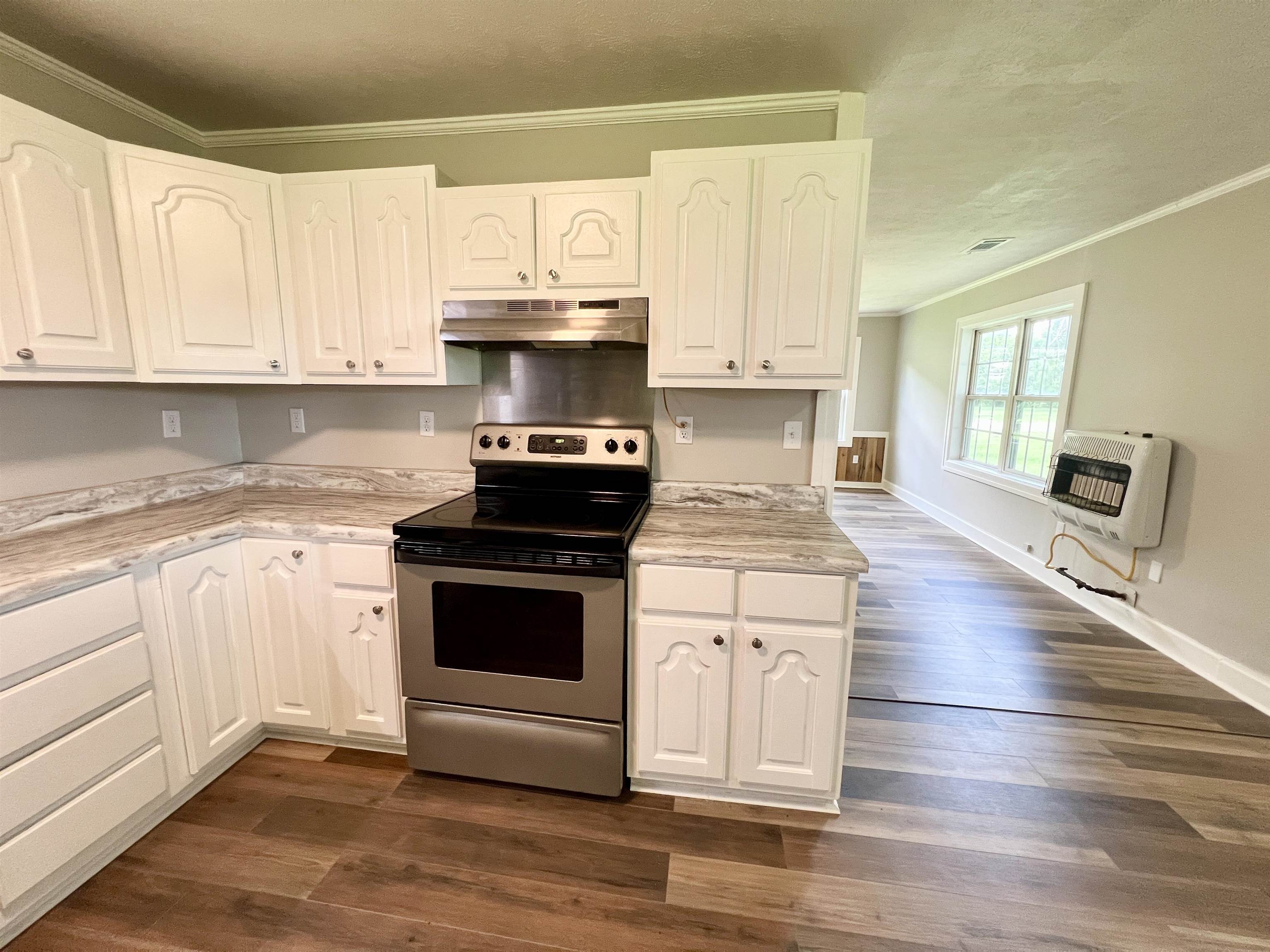 250 Ranch Street Savannah, TN 38372 - Photo 15 of 29 a kitchen with stainless steel appliances a stove a sink and white cabinets