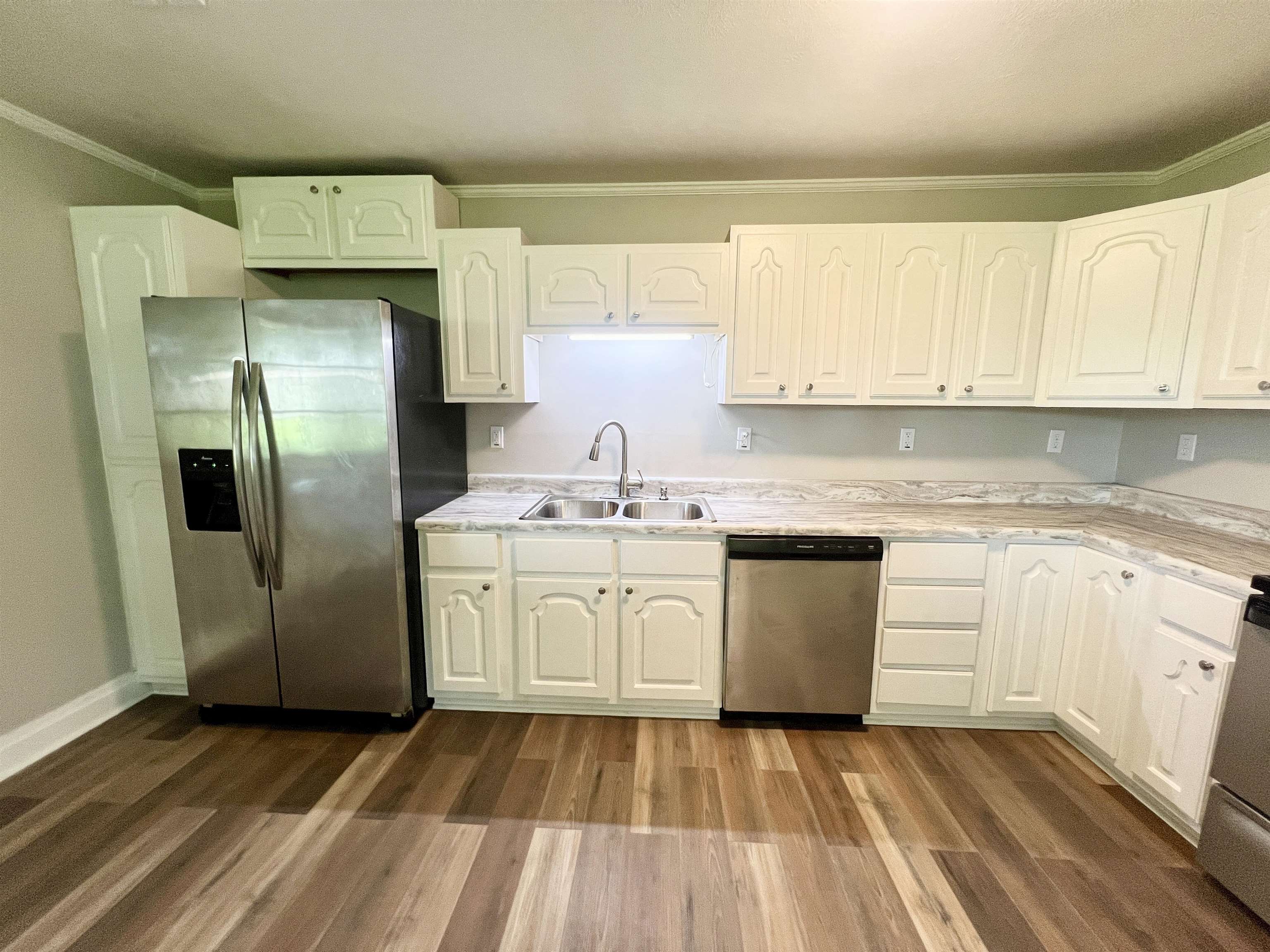 250 Ranch Street Savannah, TN 38372 - Photo 16 of 29 a kitchen with a refrigerator sink and cabinets