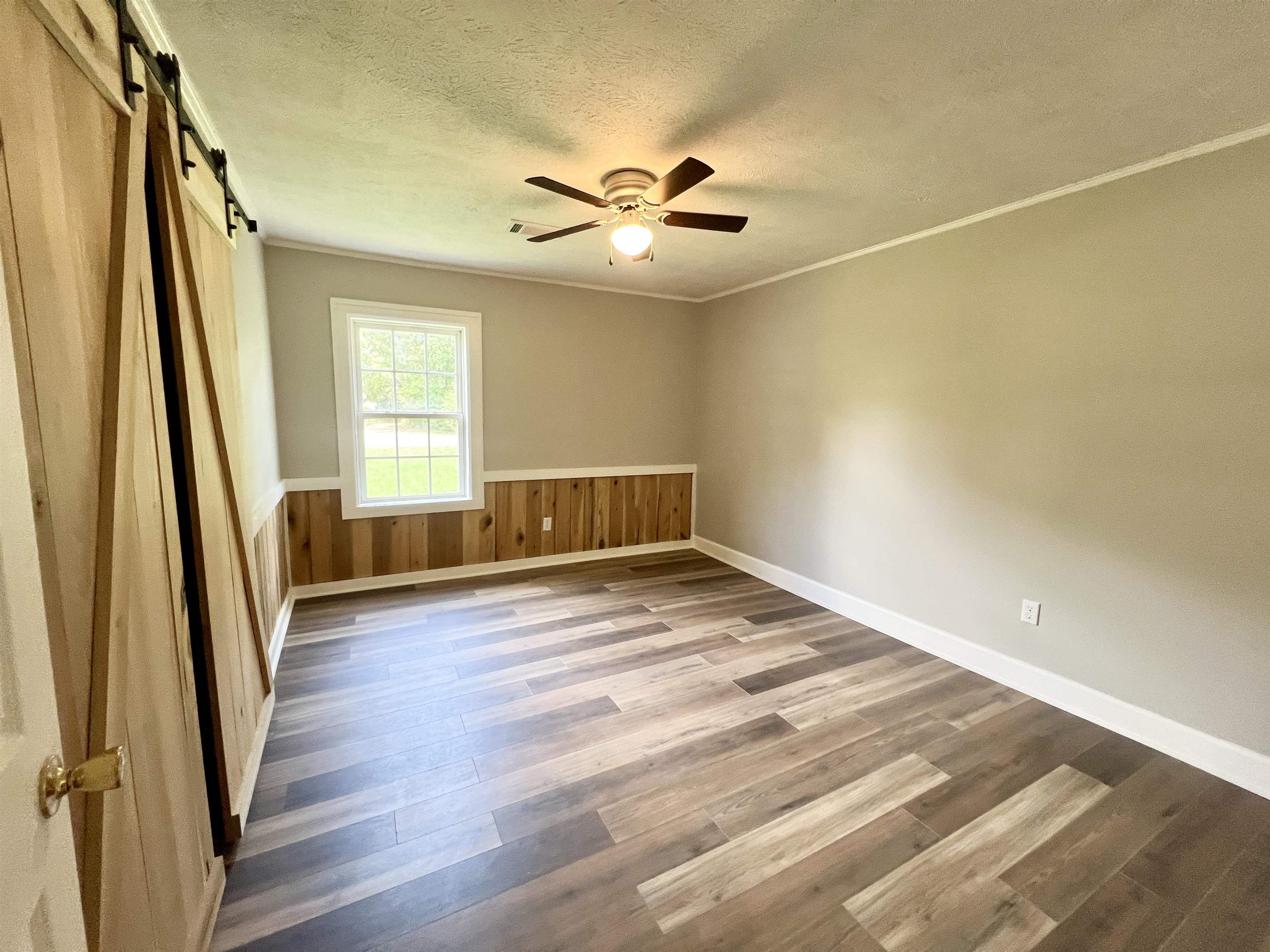 250 Ranch Street Savannah, TN 38372 - Photo 7 of 29 a view of empty room with wooden floor and fan