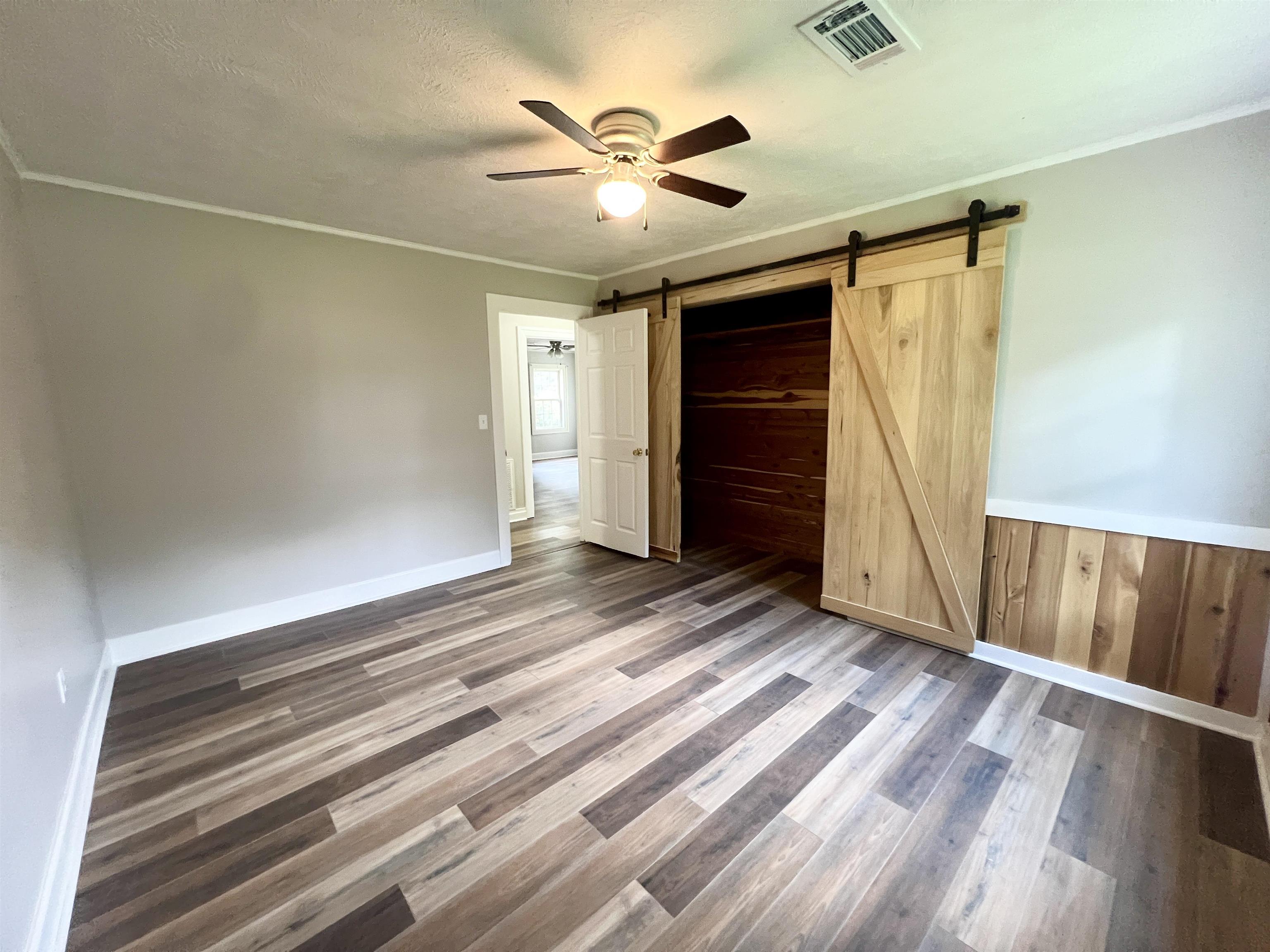 250 Ranch Street Savannah, TN 38372 - Photo 8 of 29 en empty room with wooden floor and ceiling fan