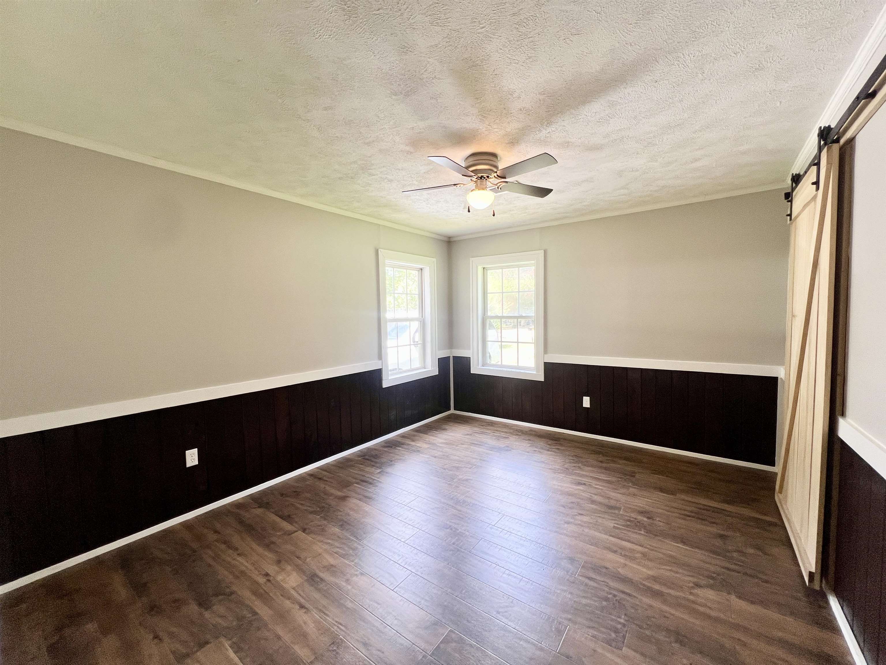250 Ranch Street Savannah, TN 38372 - Photo 9 of 29 an empty room with wooden floor and windows