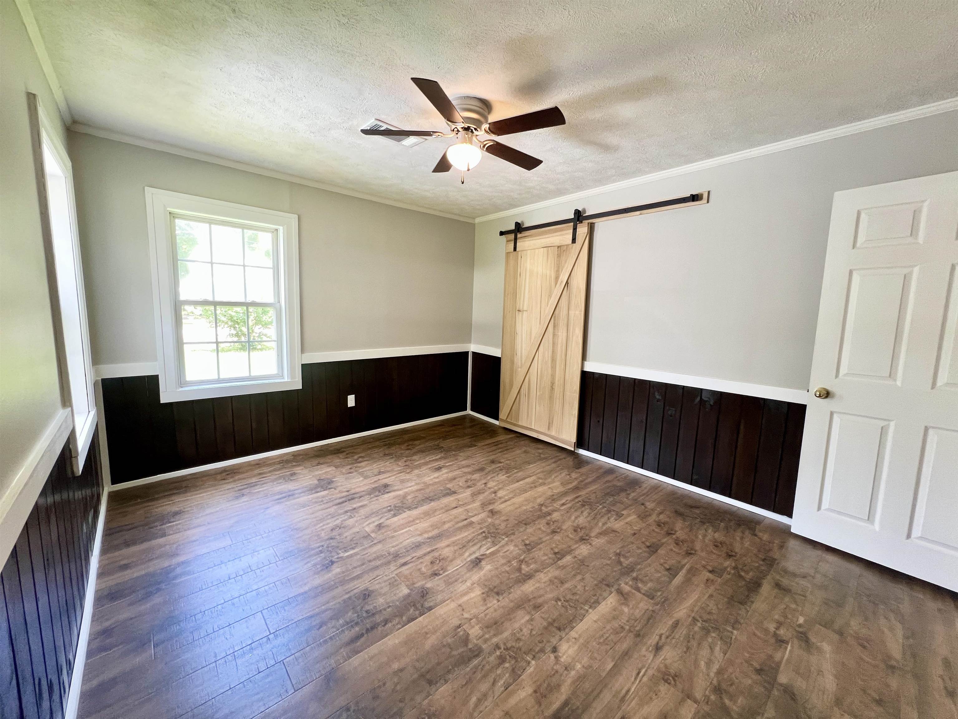 250 Ranch Street Savannah, TN 38372 - Photo 10 of 29 a view of an empty room with wooden floor and a window