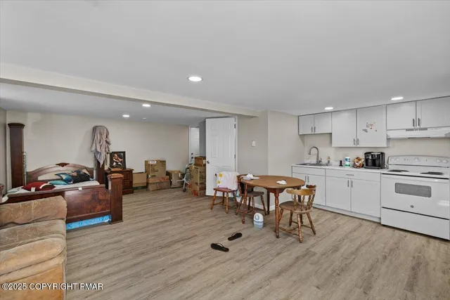 a kitchen with a table chairs refrigerator and cabinets