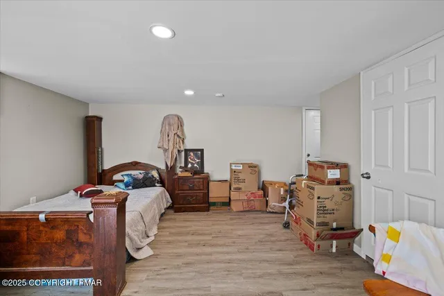 a bedroom with furniture and a window