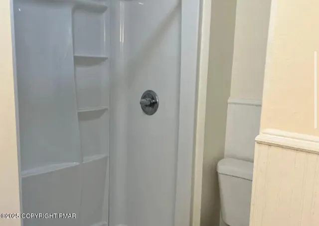 a kitchen with granite countertop white cabinets and white stove