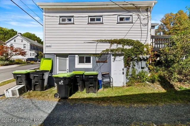 a view of a house with backyard porch and sitting area